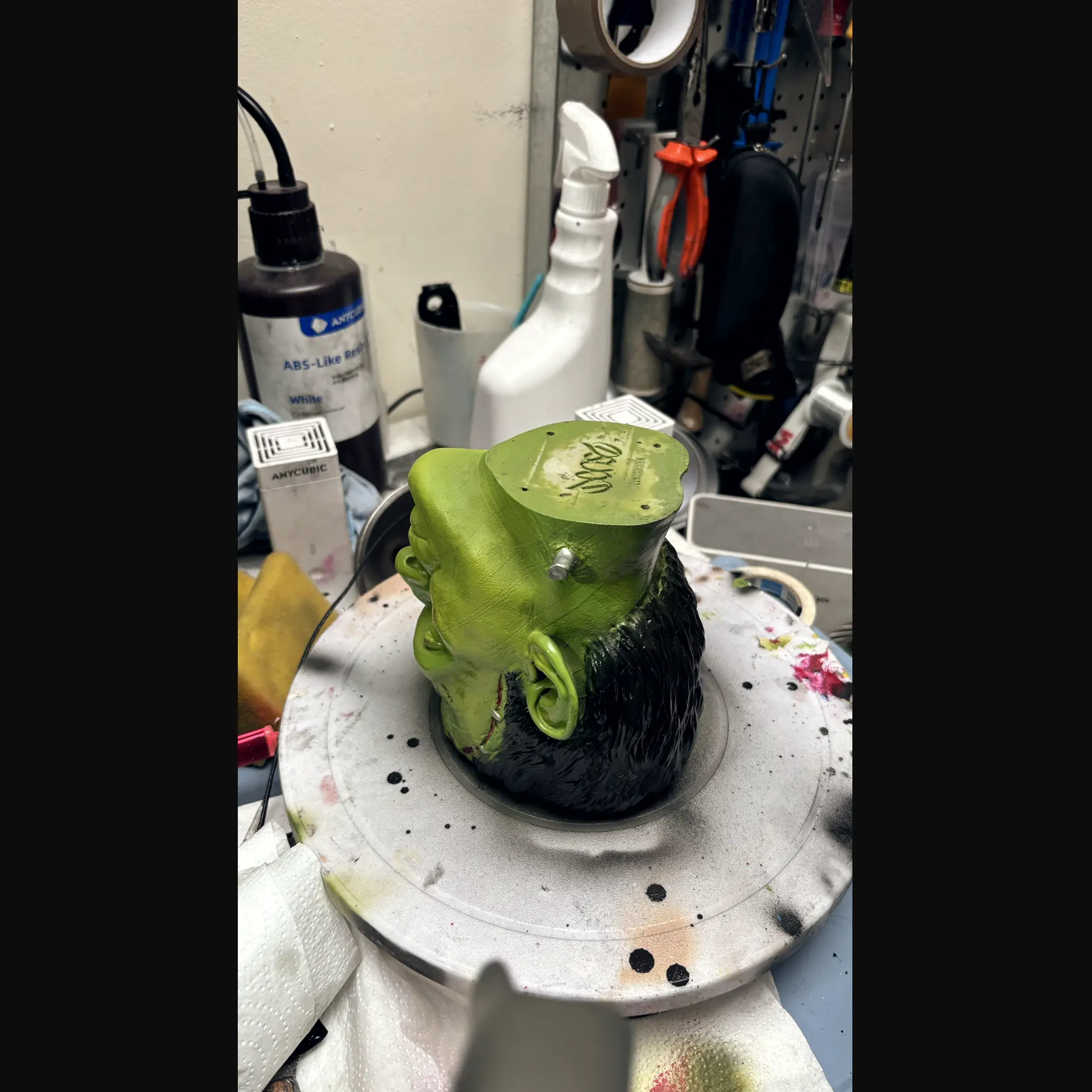 The Frankenstein cup rendered in 3D against black, seen face on, the stitches and bolts catching the light